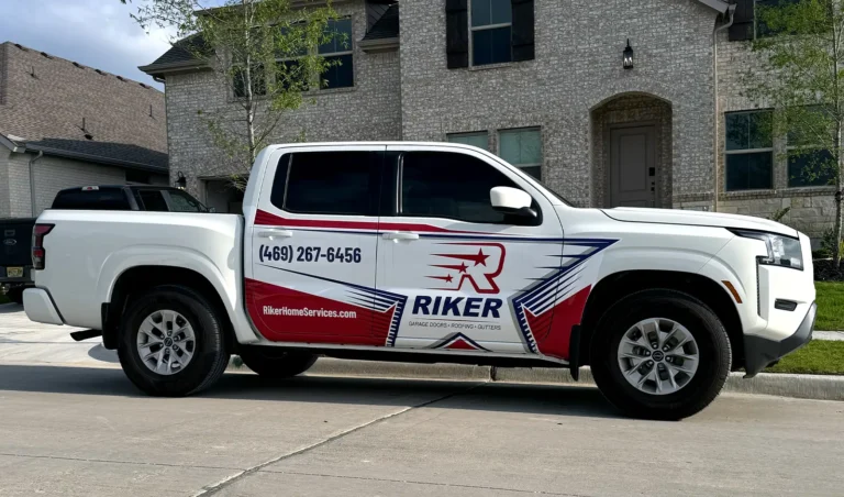 Riker Home Services pickup truck with red and blue wrap design, showcasing the logo across the doors for strong visibility.