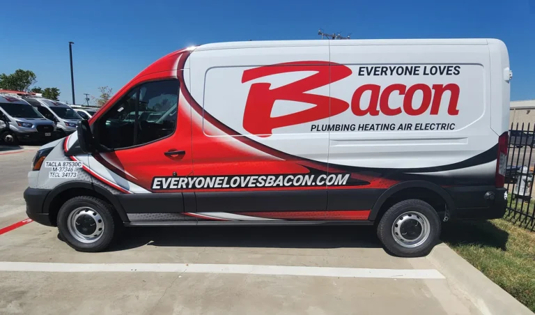 Bacon Plumbing Heating Air Electric transit van with an oversized red “Bacon” logo and sweeping wrap graphics in red, black, and white.